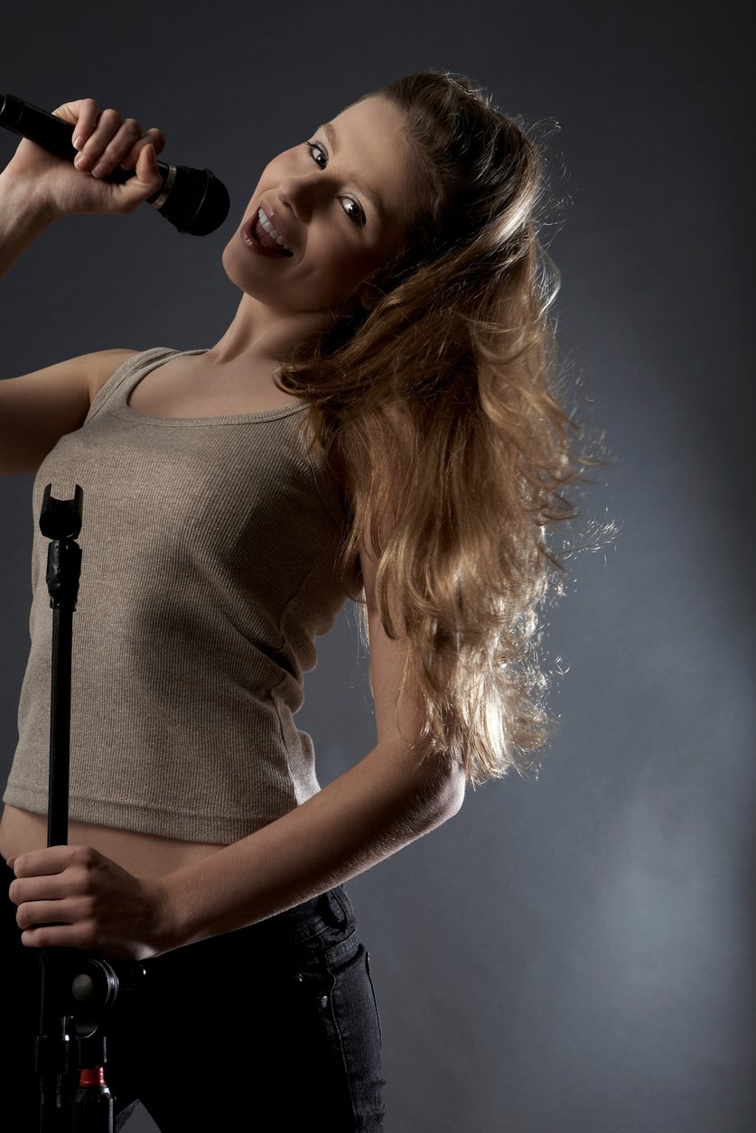 Teenage Girl Singing Into Microphone